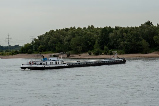 Rhin River kilometer 800, Voerde, North Rhine-Westphalia, Germany Cargo ship LENA papenburg navigating rhine river in germany.