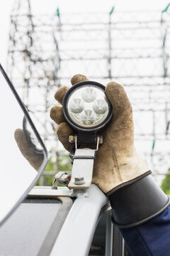 Engineer adjusting work light on vehicle