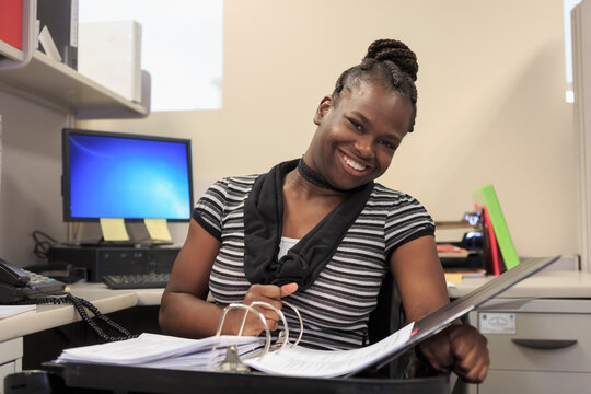 Teen with Cerebral Palsy working in an office