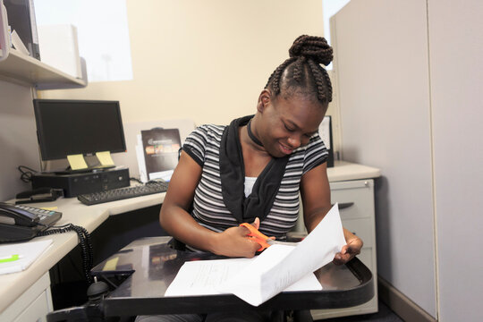 Teen with Cerebral Palsy working in an office