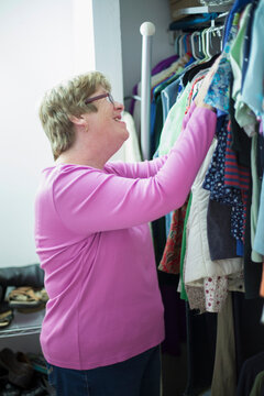 Woman with Autism choosing clothes from a rack