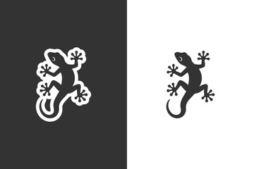 Fototapeta premium A black silhouette of a gecko is shown climbing on a white background