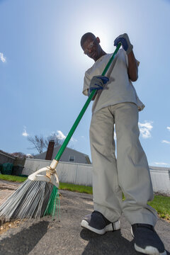 Man with Williams Syndrome cleaning up the yard