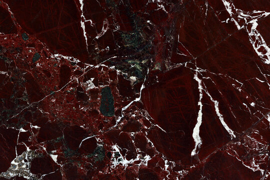 Dark burgundy red marble texture with white veins. Premium luxury crimson stone background for elegant interior layout.