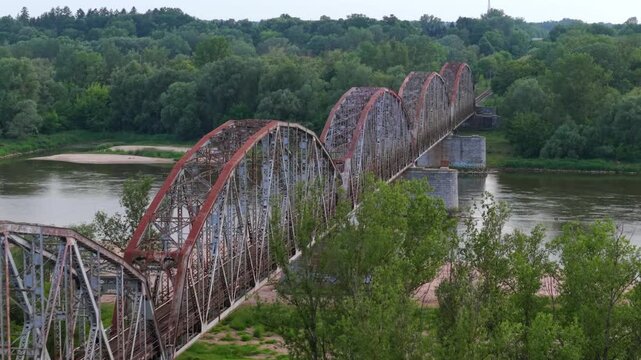 Industrial rusty old steel train bridge, aerial view.