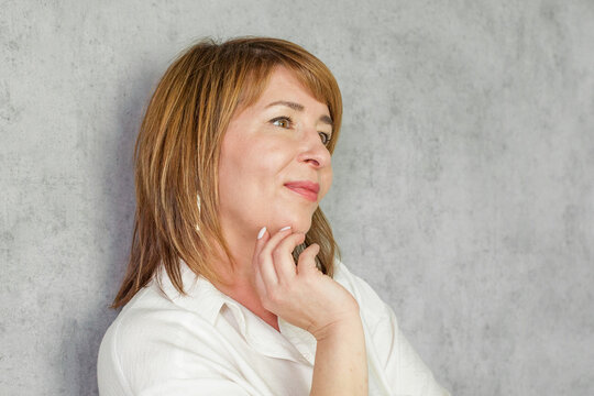 Cheerful mature red haired woman smiling cheerfully and casually with a positive happy confident and relaxed expression