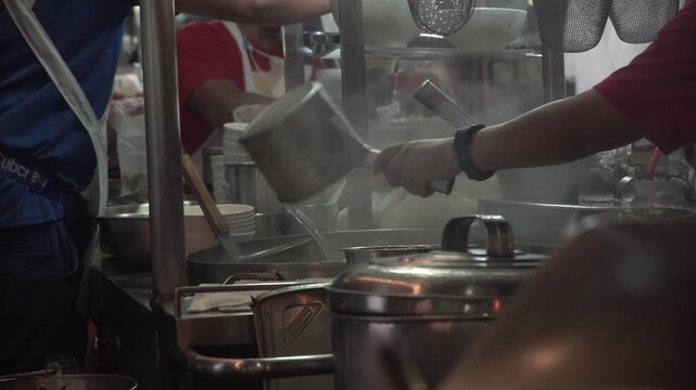 Slow-motion footage of squid being grilled as street food in Bangkok, Thailand.