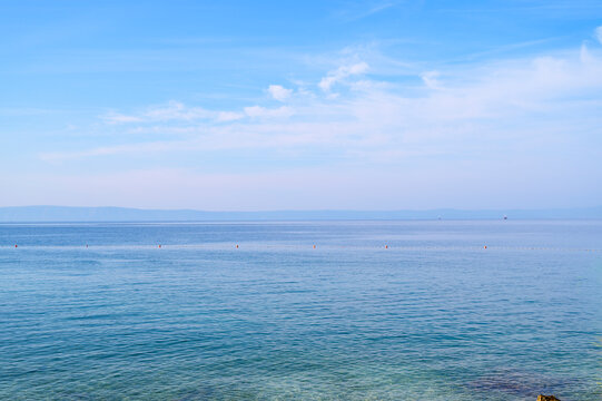 Sea surface of an absolutely calm water area during midday