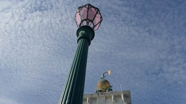 Vintage green street lantern against classical dome and sky