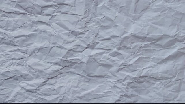 Abstract crumpled paper texture background with soft lighting. Minimal clean surface for design, presentations, typography, overlay and motion graphics.  Seamless looping 4k
