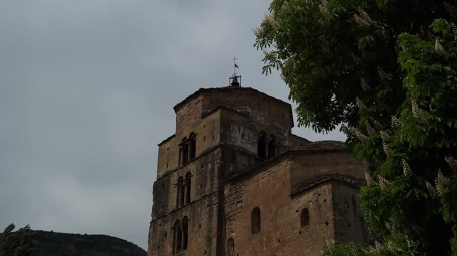 Ancient Stone Church Tower Under Cloudy Sky