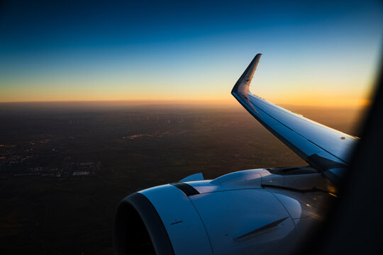 Aircraft winglet against a glowing sunset from a window seat