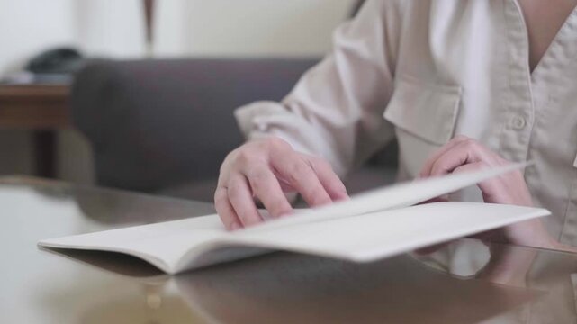 Close-up shot hand opening flipping book pages paper, literature story study, lifestyle education concept