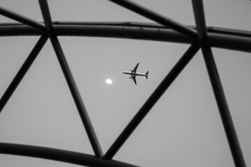 Airplane seen through a geometric glass dome roof © Tim