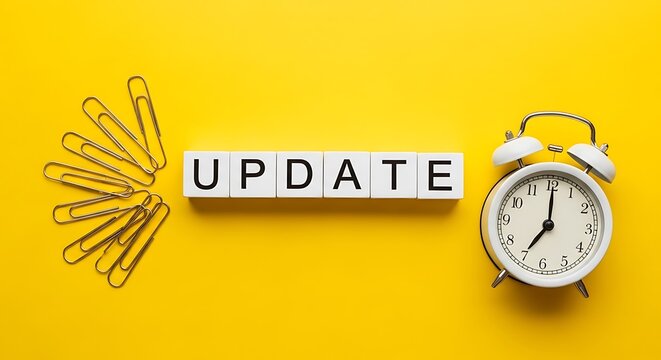 Update word on white blocks with alarm clock, business software update concept on yellow background, office productivity and time management