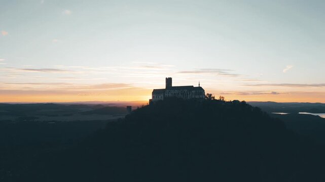 Experience the stunning aerial views of Bezdez Castle during sunset. Marvel at the medieval architecture and beautiful landscape surrounding this historic site.
