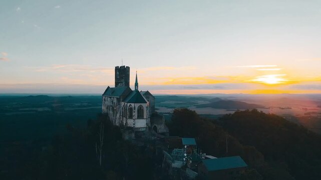 Watch as the sun sets over Bezdez Castle, illuminating the historic structure and the surrounding landscape. The evening light creates a beautiful backdrop for this ancient site.