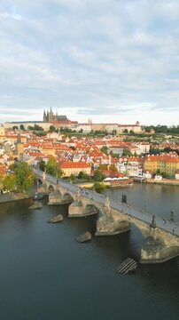 Experience a stunning aerial view of Charles Bridge and Prague Castle. This breathtaking panorama showcases the medieval architecture and vibrant colors of Prague at dawn.