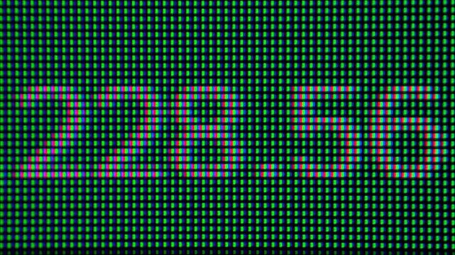 Extreme macro view of a stock price displayed on a trading terminal with visible RGB pixels. Financial markets, stock trading, investing, market data, and digital finance concept.