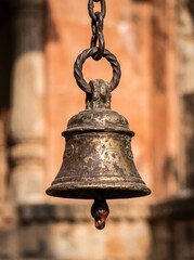 Obraz premium Vintage brass bell hanging from chain in historic architecture close-up view