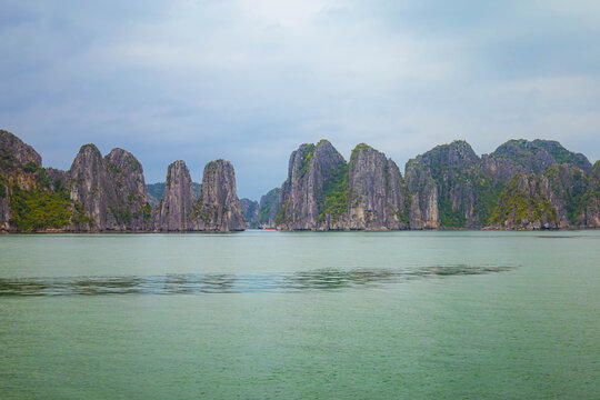 Beautiful Halong bay with layer of limestone mountians and boats in Vietnam.