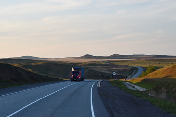Fototapeta premium Tar road at sunset Siberian scenery. Republic of Khakassia, Russia