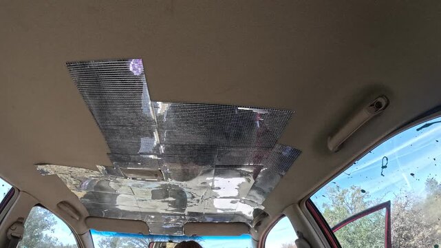 Car interior ceiling with foil patches