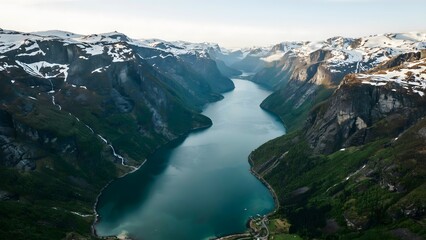 Fototapeta premium Breathtaking fjord surrounded by snow-capped mountains and lush greenery