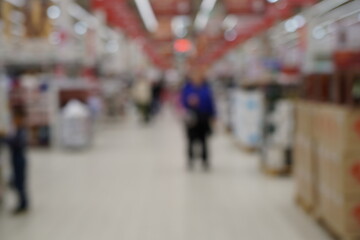 Fototapeta premium Blurred background. People buy groceries at the supermarket.