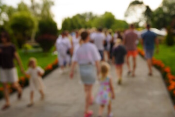 Obraz premium Blurred background. People are walking in the city park.