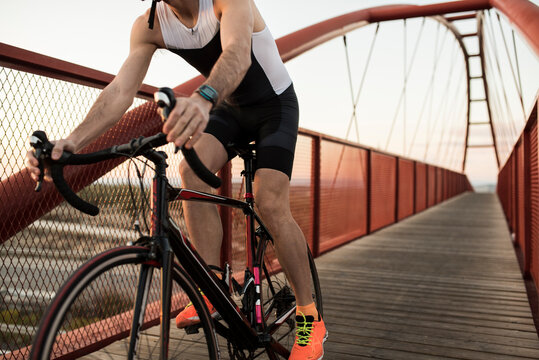 Cyclist goes over pedestrian bridge with his racing bike
