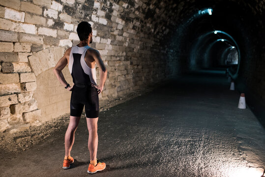 full-length portrait of runner from behind ready to run through a tunnel