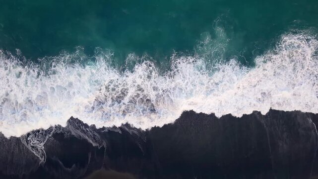 Aerial Top View of Ocean Waves Crashing on Black Sand Beach