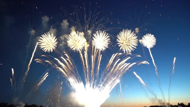 Large white firework explosion with light trails in clear blue night sky at dusk