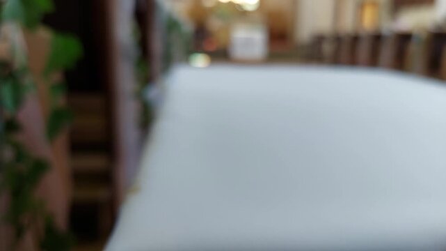 Wedding table runner with lace and gold embroidery inside a church aisle blur