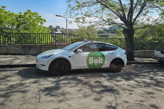 City taxi in Tbilisi, white liftback Tesla Model S. Sunlight