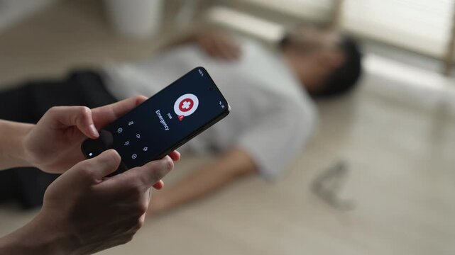 Woman calling emergency service to aid unconscious man lying on the floor