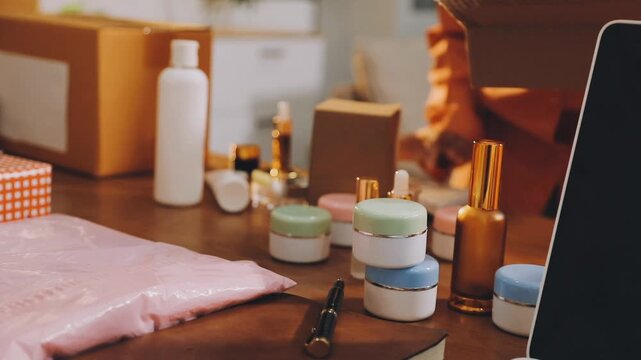 Two happy women Asian bloggers smiling and laughing while online streaming from mobile sell cosmetics makeup beauty products in living room, Concept teenagers or friends, business lifestyle at home.