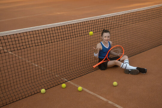 M&auml;dchen, 11, im Tennisoutfit am Tennisplatz