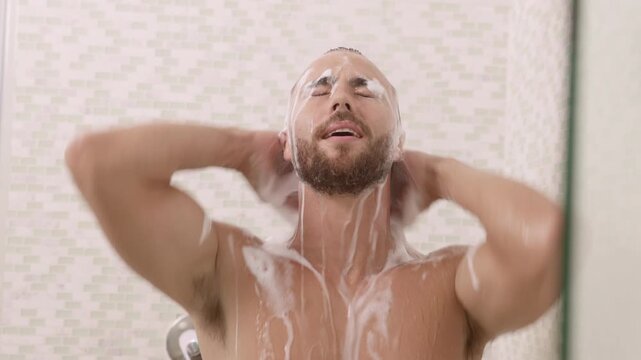 Man taking a shower and shampooing hair