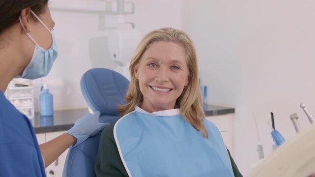 Smiling old woman looking at camera at dental clinic