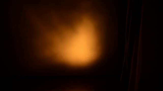 Dramatic flickering firelight casting shadows on a dimly lit wall