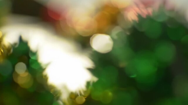 Abstract macro video of shimmering white and emerald bokeh orbs drifting dreamily, foreground; soft ruby, orange autumn hues blurred in background. Serene ambiance. Concept of ethereal tranquility