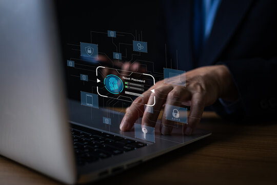 Businessman using laptop with virtual reset password screen interface. Cyber security, privacy data protection and biometric verification concept.