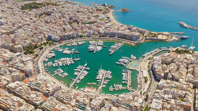 Piraeus city showing mikrolimano and marina zeas full of yachts and sailboats, surrounded by buildings and the mediterranean sea, highlighting a vibrant port town lifestyle