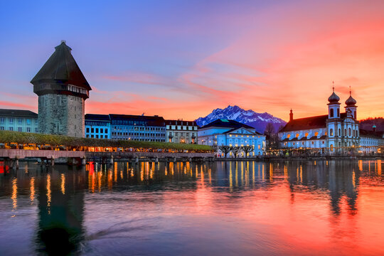 Splended sunset over the Luzern Kappelbrucke bridge and Jesuten church with Pilatus mountain at background in the evening view, Switzerland