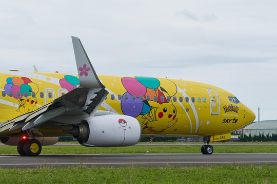 Ibaraki Airport, Japan - June 11, 2022: Skymark Airlines Boeing 737-800 (JA73AB) "Pikachu Jet BC1" winglet cherry blossom decoration and Pokeball engine nacelle close-up with Pikachu fuselage art