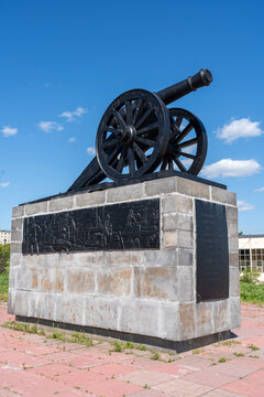 Kamenskaya cannon or gun monument or memorial on pedestal with bas-reliefs in city Kamensk-Uralsky, Sverdlovsk region, Ural. Vertical image