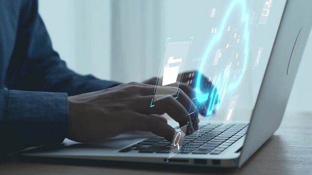 Hands Typing on Laptop with Ghosted Digital Clouds and File Icons Representing Data Management and Technology Integration in Modern Workspace. Qubit.