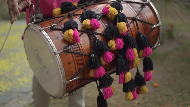 Dhol Player Performing During Celebration with Traditional Indian Drum Music, Festival Energy, Wedding Dance, and Cultural Event Atmosphere